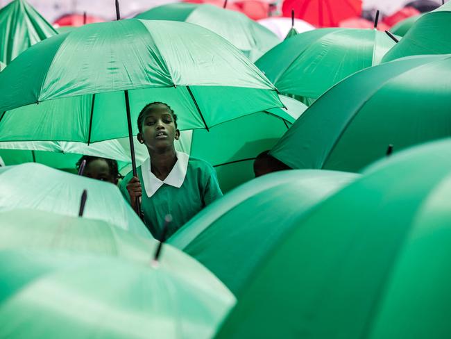 Kenyan students shelter from the sun during celebrations for Kenya's 60th Independence Day. Picture: Luis Tato/AFP