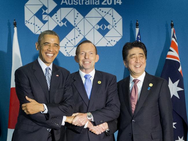 U.S. President Barack Obama, left, Australian Prime Minister Tony Abbott, centre, and Japanese Prime Minister Shinzo Abe, right, shake hands at the start of their meeting at the G20 Summit in Brisbane. AP Photo/Pablo Martinez Monsivais.