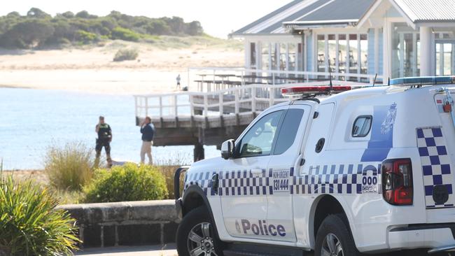 Police near the body of a person next to the At the Heads in Barwon Heads following a boating accident. Picture: Alan Barber