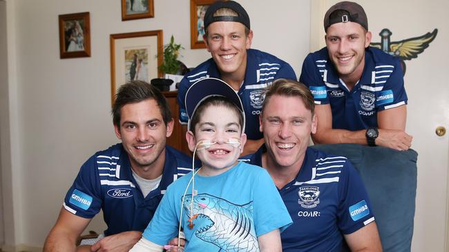 Daniel Menzel, with teammates Rhys Stanley, Mark Blicavs and Sam Menegola, dropped by to visit young patient Bryce McKiernan. Picture: Mike Dugdale