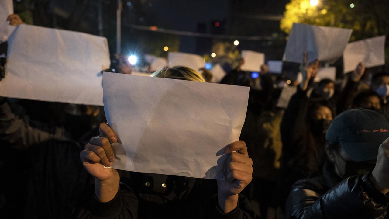 Protesters hold up a white piece of paper against censorship as they march against China’s strict zero Covid measures in Beijing, China. Picture: Kevin Frayer/Getty Images