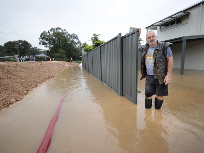 The temporary levee is backing up flood water into Martin Golledge’s home. Picture: David Caird