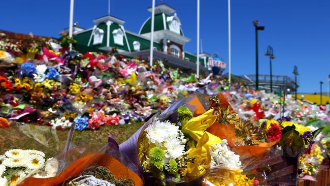 Flowers flooded the theme park as the city mourned those killed. Photo: David Clark