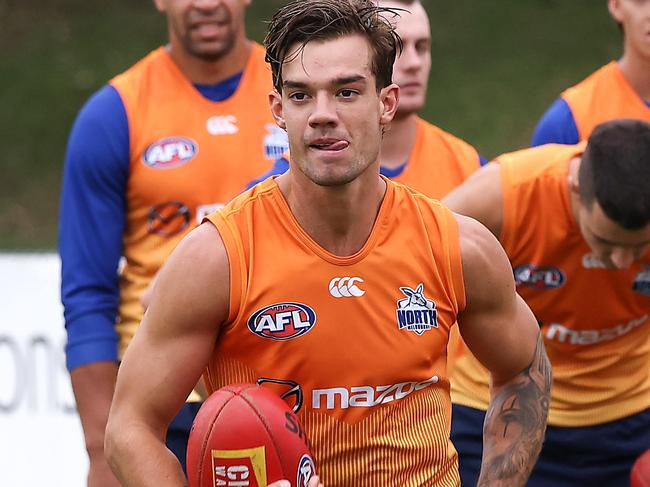 AFL. North Melbourne return to training for the 2021 AFL season.Jy Simpkin on the left does a running drill. Picture : Ian Currie