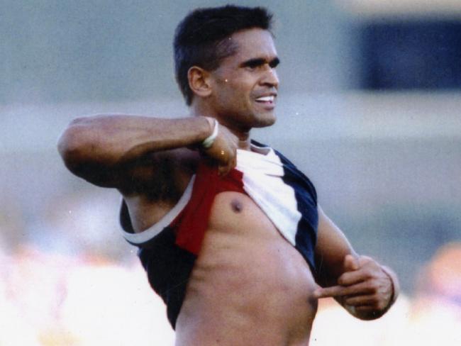 Footballer Nicky Winmar lifts his guernsey and pointing to his skin says "I'm black and I'm proud" to jeering Collingwood fans 26 Apr 1993.