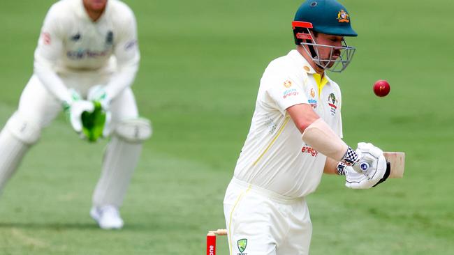 Australia's Travis Head avoids a rising delivery on the way to his 152 runs during day three of the first Ashes cricket Test match between England and Australia at the Gabba in Brisbane on December 10, 2021. (Photo by Patrick HAMILTON / AFP)