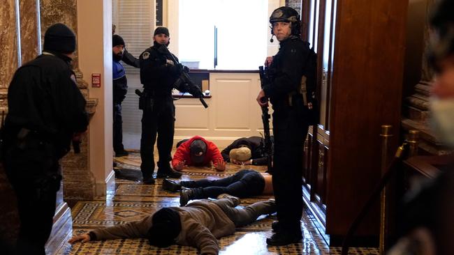 US Capitol Police detain protesters outside of the House Chamber. Picture: AFP