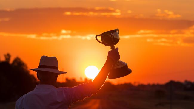 The Emirates Melbourne Cup held aloft during a glorious sunset in Longreach, central west Queensland