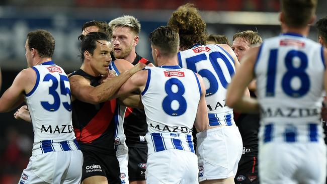 Essendon’s Dylan Shiel and Bailey Scott of the Kangaroos exchange views ay Metricon Stadium on Saturday. Picture: Getty Images