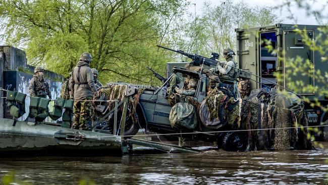 Dutch military vehicles cross the IJssel river on route to Germany for a NATO exercise this April. Picture: AFP