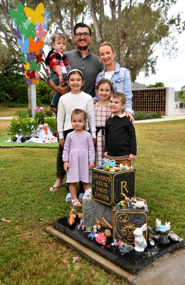 Clinton and Anastasia Taylor with Scarlet, 7, Carson, 1, Aubrey, 2, Cooper, 5, and Ruby, 9, at the headstone for Grayson at the Forever Garden at the Belgian Gardens Cemetery. Picture: Evan Morgan