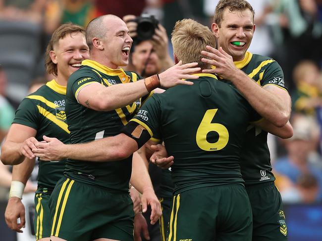 SYDNEY, AUSTRALIA - NOVEMBER 10:  Dylan Edwards, Tom Dearden and Tom Trbojevic of Australia celebrate winning the 2024 Pacific Championships Pacific Cup Men's Final match Australia Kangaroos and Tonga XIII at CommBank Stadium on November 10, 2024 in Sydney, Australia. (Photo by Matt King/Getty Images)