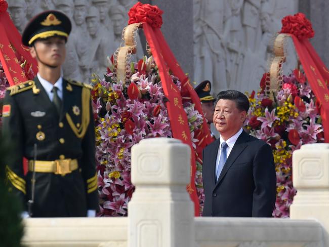 China's President Xi Jinping (C) walks around the Monument to the People's Heroes on Tiananmen Square during a wreath-laying ceremony marking Martyrs' Day at Tiananmen Square in Beijing on September 30, 2019. (Photo by MADOKA IKEGAMI / POOL / AFP)