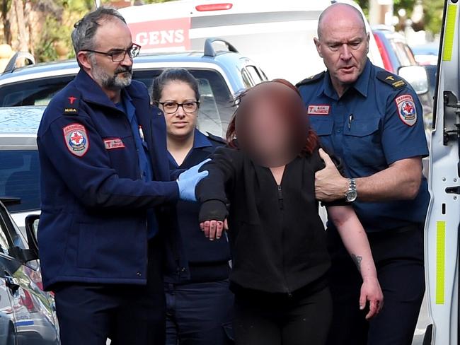 A woman is helped to an ambulance after a suspected drug overdose. Picture: Nicole Garmston.