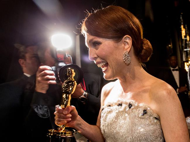 Best Actress winner Julianne Moore backstage with her statuette.