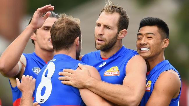 Travis Cloke is congratulated by team mates after kicking a goal during the 2017 JLT Community Series match between the Western Bulldogs and Melbourne. (Photo by Quinn Rooney/Getty Images)