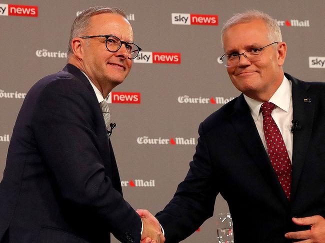 Australian Prime Minister Scott Morrison (R) shakes ahnds with leader of the opposition, Anthony Albanese, during the first leaders' debate of the 2022 federal election campaign at the Gabba in Brisbane on April 20, 2022. (Photo by Toby Zerna / various sources / AFP)