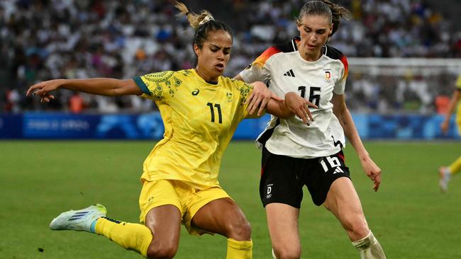 Australia's forward #11 Mary Fowler is marked by Germany's midfielder #16 Jule Brand during the women's group B football match between Germany and Australia during the Paris 2024 Olympic Games at the Marseille Stadium in Marseille on July 25, 2024. (Photo by Christophe SIMON / AFP)