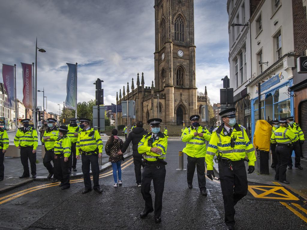 Police patrol protesters in Liverpool, where infection levels are at some of the highest in the country. Picture: Anthony Devlin/Getty Images)