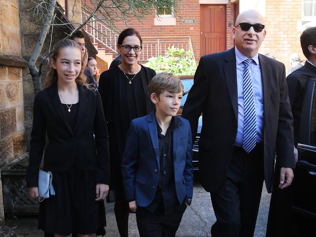 Michael Costa with his wife Deb and their children Valentina and Mikos pay their respects at the funeral. Picture: Richard Dobson