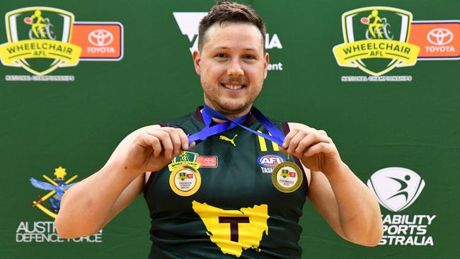 MELBOURNE, AUSTRALIA - NOVEMBER 05: Josh Christian of Tasmania poses with his Brendan Stroud and Premiers medals following the Division 2 Grand Final match between Tasmania and NSW/ACT during the 2023 Toyota AFL Wheelchair National Championships Grand Final Day at State Netball Hockey Centre on November 05, 2023 in Melbourne, Australia. (Photo by Josh Chadwick/AFL Photos/via Getty Images)