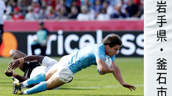 Uruguay halfback Santiago Arata crosses for the opening try of the thrilling upset of Fiji. Picture: AP