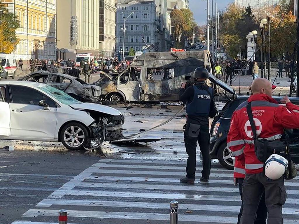 This video grab taken from an AFPTV footage shows vehicles destroyed in Kyiv as security and emergency forces work on the scene after several missile strikes. Picture: AFPTV / AFP