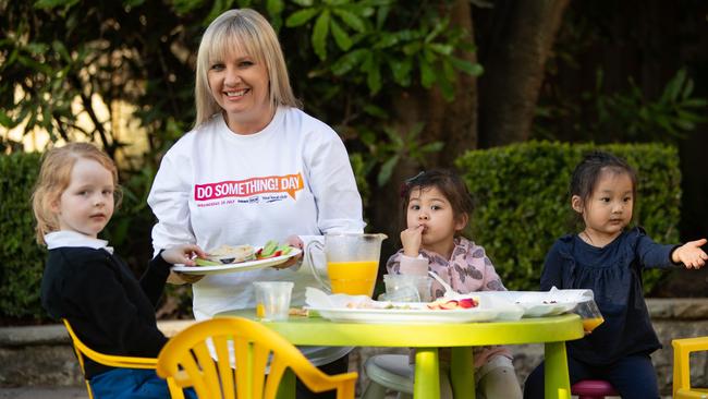 NewsLocal executive editor Louise Roberts serving children afternoon tea at Kirribilli Community Centre for DoSomething Day. Picture: Julian Andrews