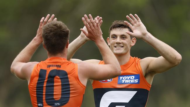 Giants Conor Stone celebrates kicking a goal  with Jacob Wehr during an AFL pre-season practice match between the GWS Giants and Gold Coast Suns at Blacktown International Sportspark on  March 4, 2023. Photo by Phil Hillyard(Image Supplied for Editorial Use only - **NO ON SALES** - Â©Phil Hillyard )