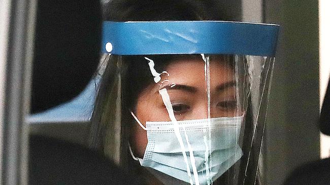 Sarah Caisip about to see her dad for the last time after his funeral at the Mt Gravatt Cemetery. she was allowed to see her father’s casket under police guard after a request to Queensland from the Prime Minister. Picture: Annette Dew