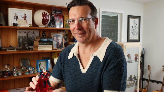 B105 radio host Stav Davidson holding his swarovski crystal superman in his favourite part of the house close to his guitars and figurines, The Gap. Picture: Liam Kidston