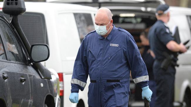 Forensic investigators outside the Cranbourne North home. Picture: Lawrence Pinder