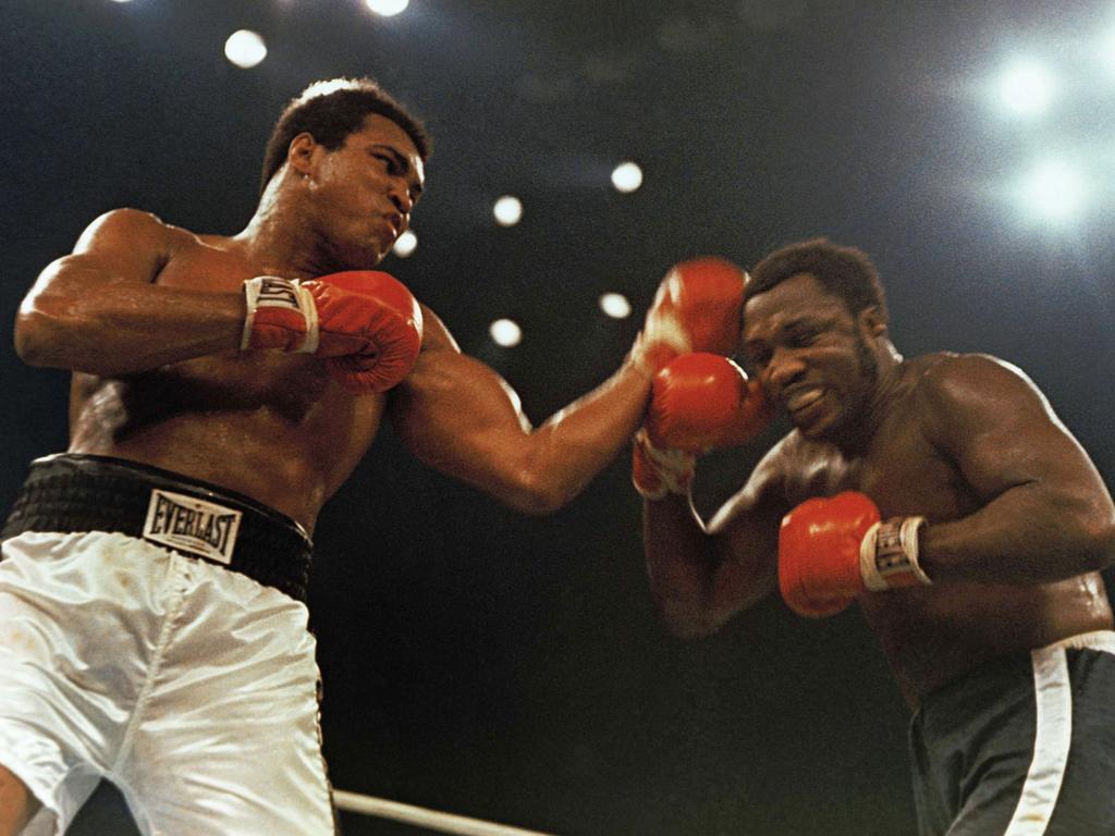 January 28, 1974: Ali (left) in a 12-round non-title fight with Joe Frazier at Madison Square Garden, New York.