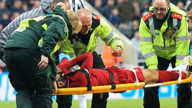 Mohamed Salah is placed on a stretcher by paramedics.