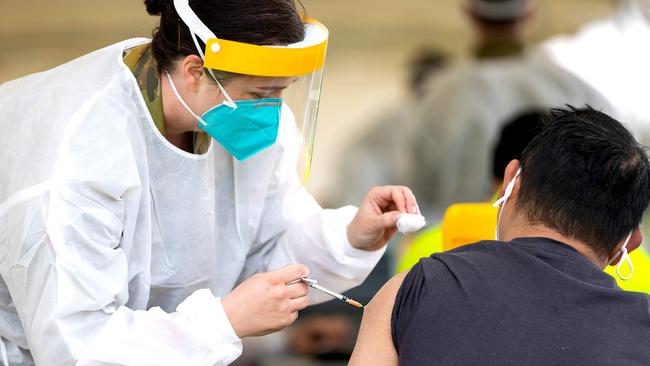 Army Medical Officer Major Bethan Ganderton administer a Covid-19 vaccine at the Dubbo Mass Vaccination centre in Dubbo. Picture: AFP