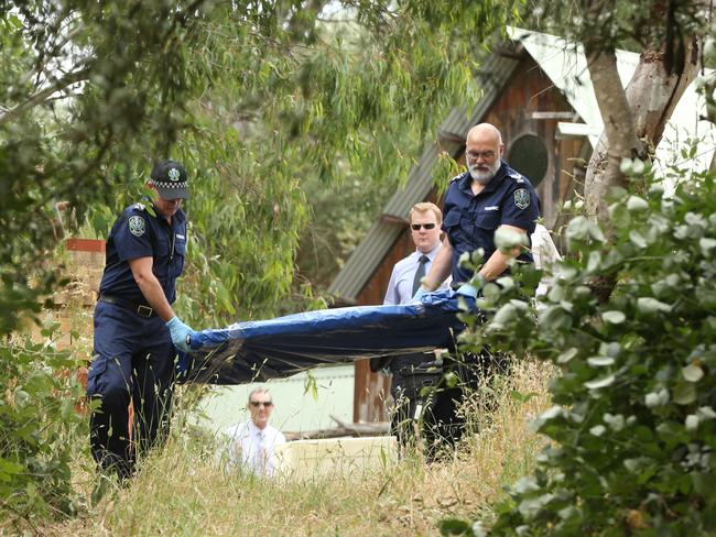 Police investigators carry out evidence from the house where Dale McCauley was living in Willunga. Picture: Tait Schmaal