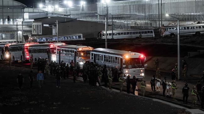 Buses carrying alleged gang members departed from the US arrive at the Terrorism Confinement Centre in the city of Tecoluca, El Salvador. Picture: El Salvador’s Presidency Press Office / AFP