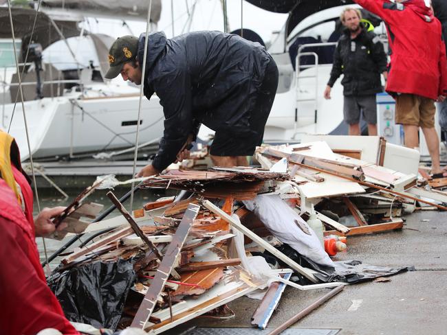 Pictured are staff at the Newport Anchorage in Newport clearing debris from a sunken yacht where it is thought a gas bottle exploded causing massive damage an injuring a female occupant who is in hospital with lacerations to her lower legs.Picture: Richard Dobson