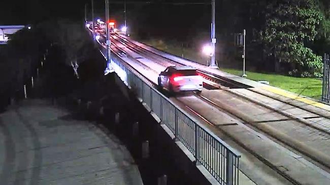 A car driving along tracks on a viaduct near G:Link’s Southport depot, some distance from the nearest public road. Picture: GoldlinQ