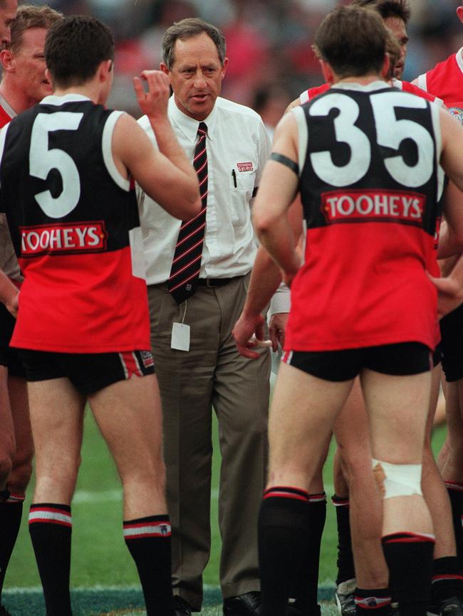 Coach Stan Alves talks to Austinn Jones and Robert Harvey during three-quarter time of the 1997 grand final.