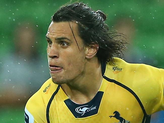 MELBOURNE, AUSTRALIA - FEBRUARY 28: Matt Toomua of the Brumbies passes the ball whilst being tackled during the round three Super Rugby match between the Rebels and the Brumbies at AAMI Park on February 28, 2015 in Melbourne, Australia. (Photo by Quinn Rooney/Getty Images)