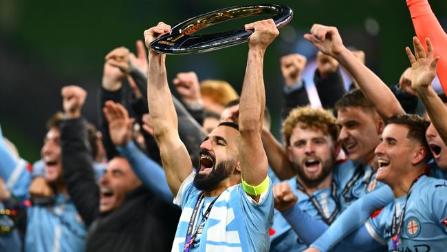 MELBOURNE, AUSTRALIA - MAY 31: Aziz Behich of the City holds aloft the A-League Men Championship trophy after winning the A-League Men Grand Final match between Melbourne City and Melbourne Victory at AAMI Park on May 31, 2025, in Melbourne, Australia. (Photo by Quinn Rooney/Getty Images)
