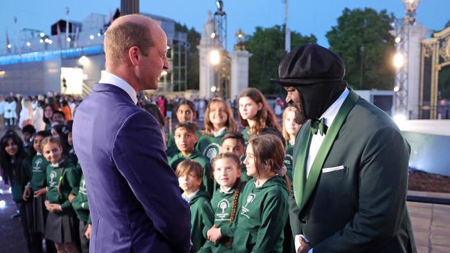 Britain's Prince William, Duke of Cambridge speaks with US singer Gregory Porter at a special ceremony for the lighting of the Principal Beacon at Buckingham Palace in London. Picture: AFP