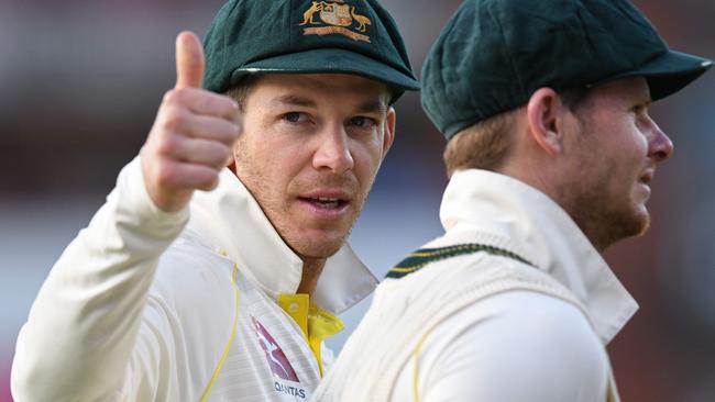 Australia's captain Tim Paine (L) gestures beside Australia's Steve Smith as his players celebrate their victory on the field after the fourth Ashes cricket Test match between England and Australia at Old Trafford in Manchester, north-west England on September 8, 2019. - Australia retained the Ashes with a 185-run thrashing of England in the fourth Test at Old Trafford on Sunday. (Photo by Oli SCARFF / AFP) / RESTRICTED TO EDITORIAL USE. NO ASSOCIATION WITH DIRECT COMPETITOR OF SPONSOR, PARTNER, OR SUPPLIER OF THE ECB