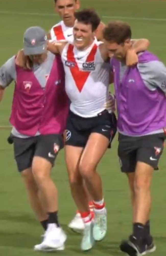 Errol Gulden is helped from the field after injuring his ankle