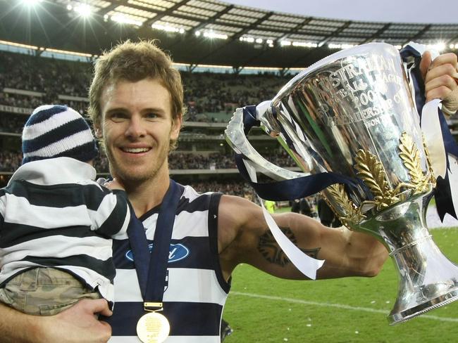 2007 Grand Final. Geelong v Port Adelaide. MCG. Cameron Mooney with the premiership cup and his son Jagger.