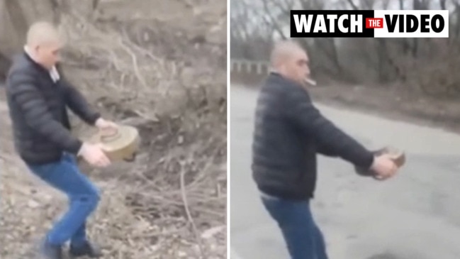 Moment man carefully disposes of anti-tank mine while smoking a cigarette
