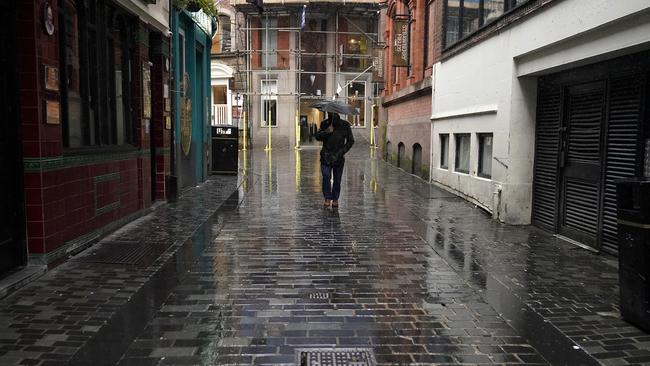 A man walks through a deserted Mathew Street, in the heart of Liverpool’s nightlife. Picture: Getty Images.