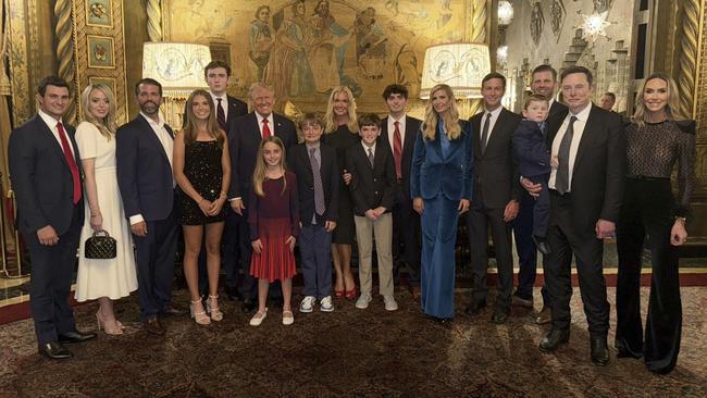 Donald Trump with his family and their partners, with Elon Musk and his son.