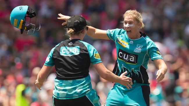 Delissa Kimmince hurls off her helmet after the Heat secured their WBBL championship. Picture: Steve Christo